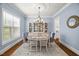 Elegant dining room featuring hardwood floors, chandelier lighting, and stylish furnishings at 325 Forest Bridge Rd, Youngsville, NC 27596