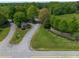 View of gated entrance to a residential community with lush trees and manicured lawn at 325 Forest Bridge Rd, Youngsville, NC 27596