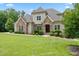 Beautiful home with stone accents, manicured lawn, and mature trees in a lovely setting at 325 Forest Bridge Rd, Youngsville, NC 27596