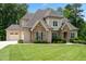 Charming home featuring stone accents, a manicured lawn, and attached garage at 325 Forest Bridge Rd, Youngsville, NC 27596