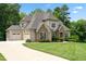 Charming two-story home with stone accents, a well-manicured lawn and an attached garage at 325 Forest Bridge Rd, Youngsville, NC 27596