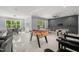 Spacious game room offers abundant natural light, foosball, ping pong and shuffleboard at 325 Forest Bridge Rd, Youngsville, NC 27596