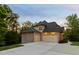 New construction home with three car garage, pristine driveway, and neatly manicured lawn at 325 Forest Bridge Rd, Youngsville, NC 27596