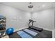Well-lit home gym features black rubber floor, a treadmill and yoga mats at 325 Forest Bridge Rd, Youngsville, NC 27596