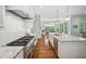 Open kitchen featuring a granite island with stainless steel appliances and wood flooring at 325 Forest Bridge Rd, Youngsville, NC 27596
