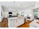 Open-concept kitchen with stainless steel appliances, a center island, and views into a living room area at 325 Forest Bridge Rd, Youngsville, NC 27596