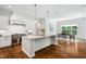 Bright kitchen showcases an island, stainless steel appliances, and is open to a dining area with hardwood floors at 325 Forest Bridge Rd, Youngsville, NC 27596