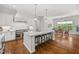 Bright kitchen boasts an island with bar seating, stainless appliances, and granite countertops at 325 Forest Bridge Rd, Youngsville, NC 27596