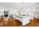 Spacious kitchen boasts white cabinets, stainless steel appliances, marble countertops, hardwood floors, and ample counter space at 325 Forest Bridge Rd, Youngsville, NC 27596
