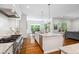 Gourmet kitchen featuring white cabinetry, granite countertops, and an island with sink at 325 Forest Bridge Rd, Youngsville, NC 27596