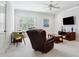 Comfortable living room with a leather recliner, ceiling fan, and a window offering natural light at 325 Forest Bridge Rd, Youngsville, NC 27596