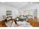 Comfortable living room with neutral colors, hardwood floors, and an open layout to the kitchen and dining spaces at 325 Forest Bridge Rd, Youngsville, NC 27596