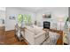 Bright living room featuring a fireplace, large windows, and hardwood floors at 325 Forest Bridge Rd, Youngsville, NC 27596