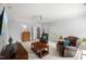 Spacious living room with neutral carpet, ceiling fan, and comfortable leather furniture at 325 Forest Bridge Rd, Youngsville, NC 27596