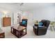Spacious living room with leather chairs, a wooden coffee table, neutral carpet, and bright white walls at 325 Forest Bridge Rd, Youngsville, NC 27596