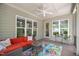 Inviting covered patio with comfortable seating, ceiling fan, and bright floral rug at 325 Forest Bridge Rd, Youngsville, NC 27596