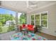 Relaxing screened-in porch with views of nature, an outdoor fan, and comfortable seating at 325 Forest Bridge Rd, Youngsville, NC 27596
