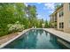 Resort-style pool with lush landscaping, outdoor seating, and a private screened-in back porch at 325 Forest Bridge Rd, Youngsville, NC 27596