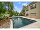 Backyard features a large, private swimming pool with stone decking and poolside lounge chairs at 325 Forest Bridge Rd, Youngsville, NC 27596