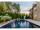 Backyard features a large, private swimming pool with stone decking and poolside lounge chairs at 325 Forest Bridge Rd, Youngsville, NC 27596