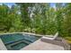 Beautiful in-ground pool with a tanning ledge and lush landscaping offering a private backyard oasis at 325 Forest Bridge Rd, Youngsville, NC 27596