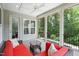 Covered porch with comfortable seating, ceiling fan, and views of the backyard, ideal for outdoor relaxation at 325 Forest Bridge Rd, Youngsville, NC 27596