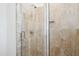 Modern tiled shower featuring a glass door and a built-in niche for toiletries at 325 Forest Bridge Rd, Youngsville, NC 27596