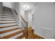 Elegant staircase with hardwood steps and wrought iron railing leads to the upper level at 325 Forest Bridge Rd, Youngsville, NC 27596