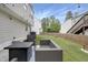 Inviting backyard featuring stylish patio furniture, a well-manicured lawn, and ambient string lights at 3613 Ranbir Dr, Durham, NC 27713