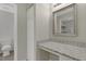 Bathroom vanity with granite countertop, stylish mirror, and closet for ample storage at 3613 Ranbir Dr, Durham, NC 27713