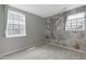 Charming bedroom featuring a scenic wall mural and two bright windows with views of the neighborhood at 3613 Ranbir Dr, Durham, NC 27713