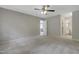 Bright bedroom with neutral walls, plush carpet, and a hallway with a bathroom and living area at 3613 Ranbir Dr, Durham, NC 27713