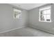 Bright bedroom with carpeted floors featuring two windows providing ample natural light at 3613 Ranbir Dr, Durham, NC 27713