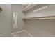 Walk-in closet with white shelving, rods, and a carpeted floor for storing clothes and accessories at 3613 Ranbir Dr, Durham, NC 27713