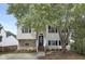 Charming two-story home featuring stone accents, black shutters, and a well-maintained front yard at 3613 Ranbir Dr, Durham, NC 27713