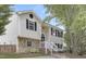 Two-story home with stone accents and black shutters with a walkway up to the front door at 3613 Ranbir Dr, Durham, NC 27713