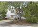 Charming home with stone accents and white siding partially obstructed by trees at 3613 Ranbir Dr, Durham, NC 27713