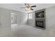 Spacious living room featuring a stone fireplace, TV, and an open doorway leading to a sunroom at 3613 Ranbir Dr, Durham, NC 27713