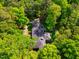 Aerial shot of a beautiful home nestled amongst lush green trees in a serene setting at 3804 Nottaway Rd, Durham, NC 27707