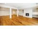 The basement features hardwood floors, recessed lighting, and a painted brick fireplace at 3804 Nottaway Rd, Durham, NC 27707