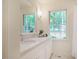Bright bathroom features marble countertops, a large window, and ample natural light at 3804 Nottaway Rd, Durham, NC 27707