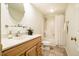 This is a bathroom with a white shower curtain and wooden cabinets at 3804 Nottaway Rd, Durham, NC 27707