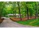 Charming single-story home with a lush, wooded front yard and curved driveway at 3804 Nottaway Rd, Durham, NC 27707