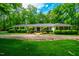 Charming home exterior featuring lush green lawn and manicured landscaping at 3804 Nottaway Rd, Durham, NC 27707