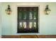 Inviting front entryway with black double doors, decorative lanterns, and brick flooring at 3804 Nottaway Rd, Durham, NC 27707