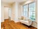 Bench seat next to bright windows highlights the hardwood flooring and natural light at 3804 Nottaway Rd, Durham, NC 27707