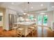 Spacious kitchen featuring a large island with seating, stainless steel appliances, and access to a porch at 3804 Nottaway Rd, Durham, NC 27707