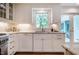Kitchen featuring white cabinets, granite countertops, and stainless steel appliances; window with natural light at 3804 Nottaway Rd, Durham, NC 27707