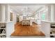 Open-concept kitchen with an island featuring seating, stainless steel appliances, and hardwood floors at 3804 Nottaway Rd, Durham, NC 27707