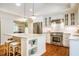 Modern kitchen with stainless steel appliances, a granite island, and white cabinetry at 3804 Nottaway Rd, Durham, NC 27707
